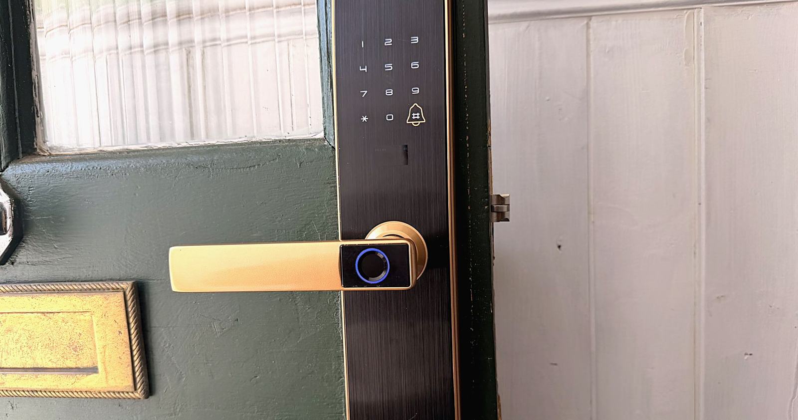 A digital lock fitted to a painted timber front door.