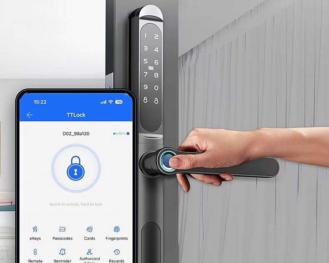 The lock being opened by fingerprint alongside the manufacturer's app on a phone.