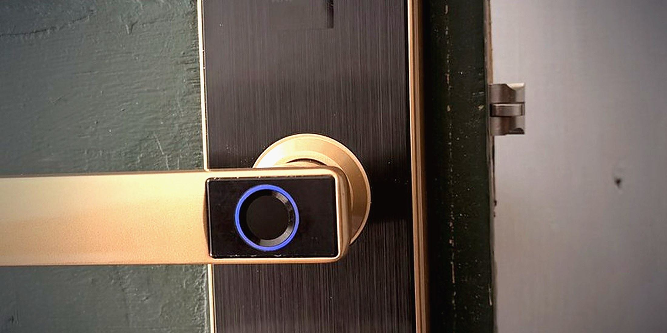 A brick house front door under an arched porch, the kind of existing doorway most smart locks have to be fitted to.